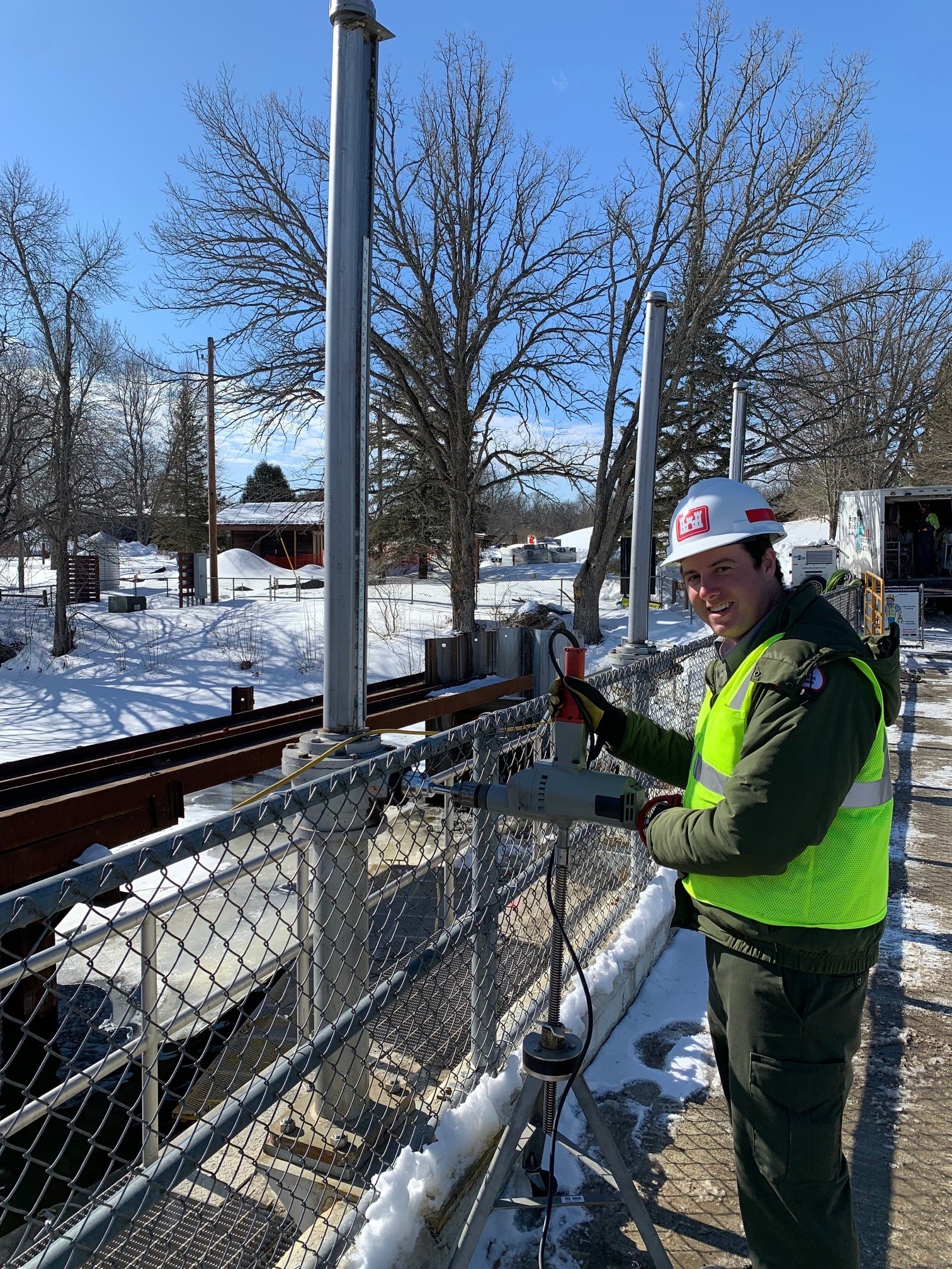 A man at a construction site at a dam in the winter