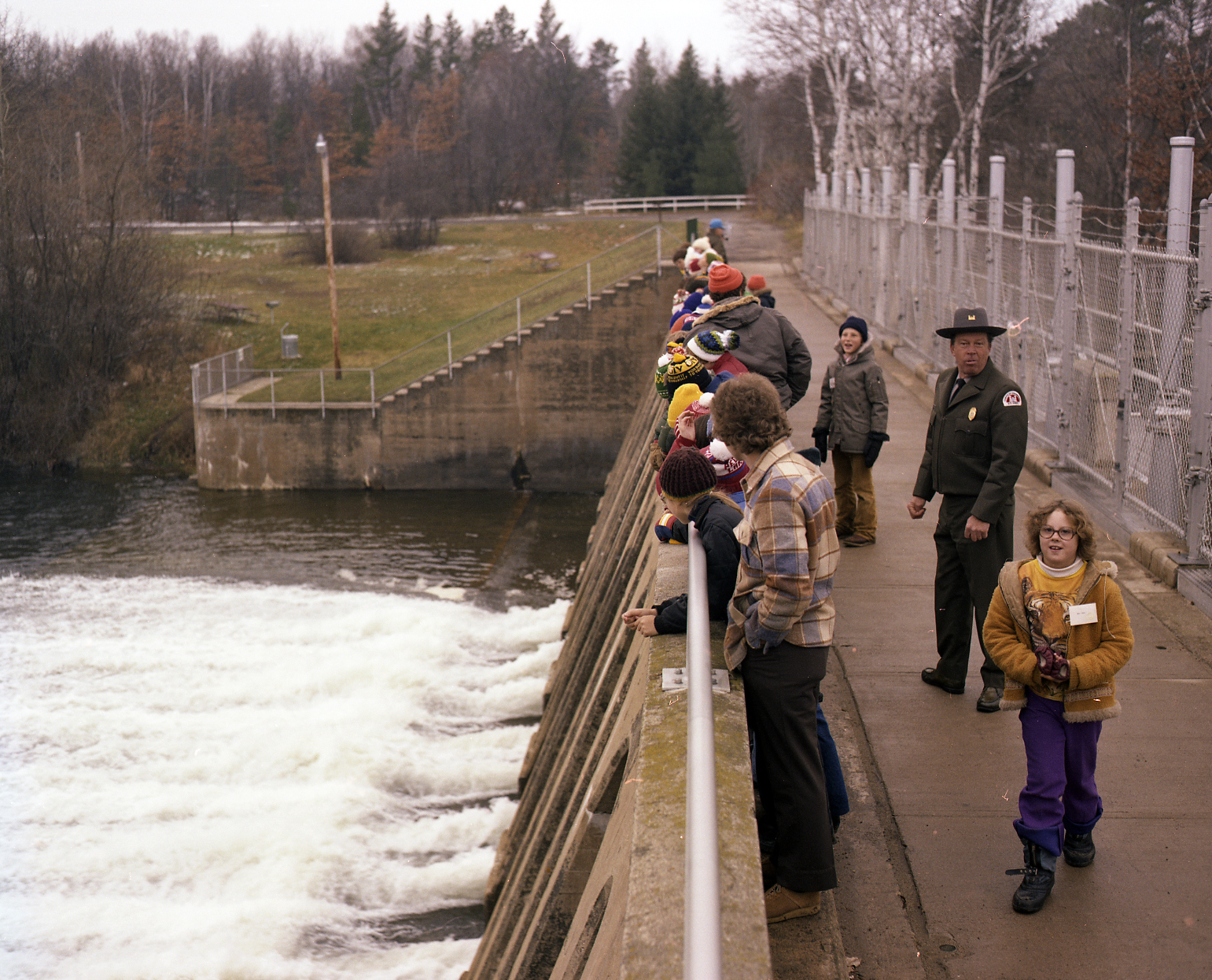 Park manager with children on top of Pine River Dam