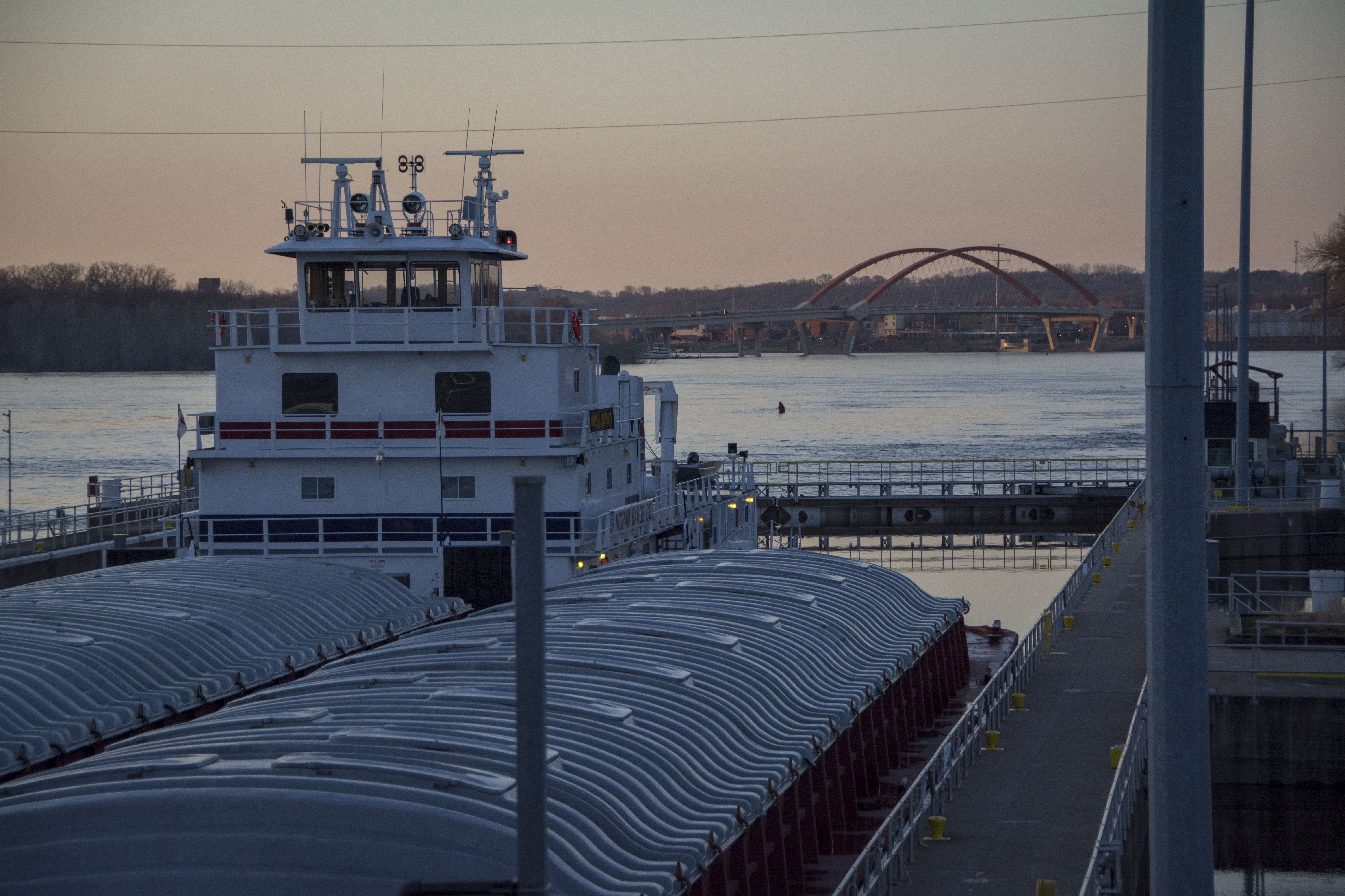 A barge locking through with a bridge in the background