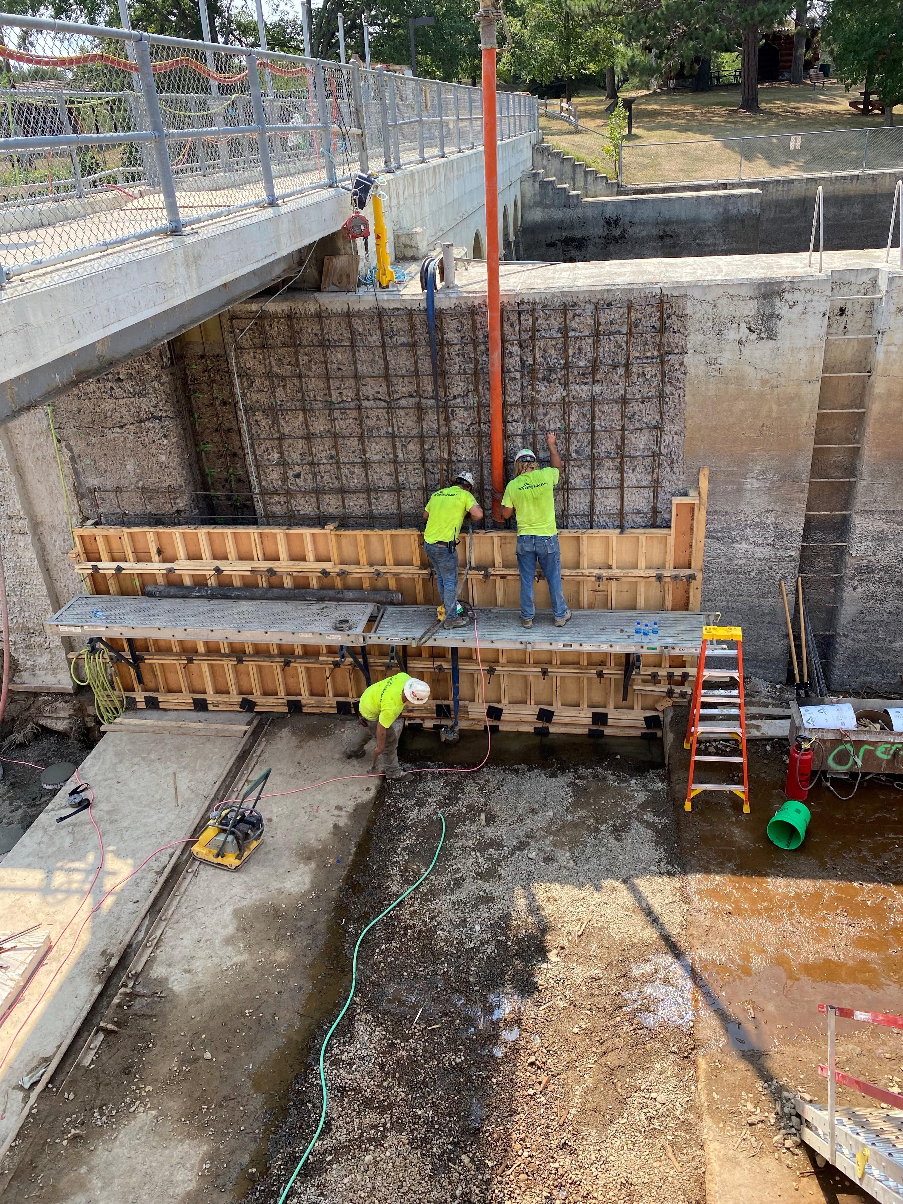 Two people work on a construction site